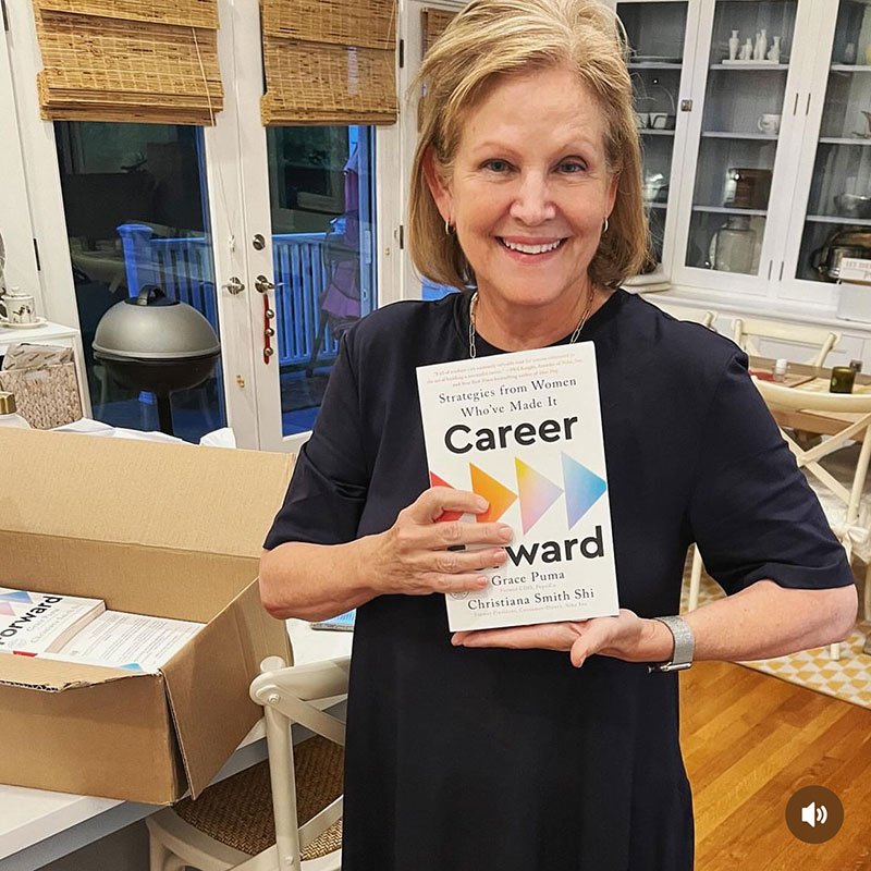 Author Christiana Smith holding a copy of her book, Career Forward
