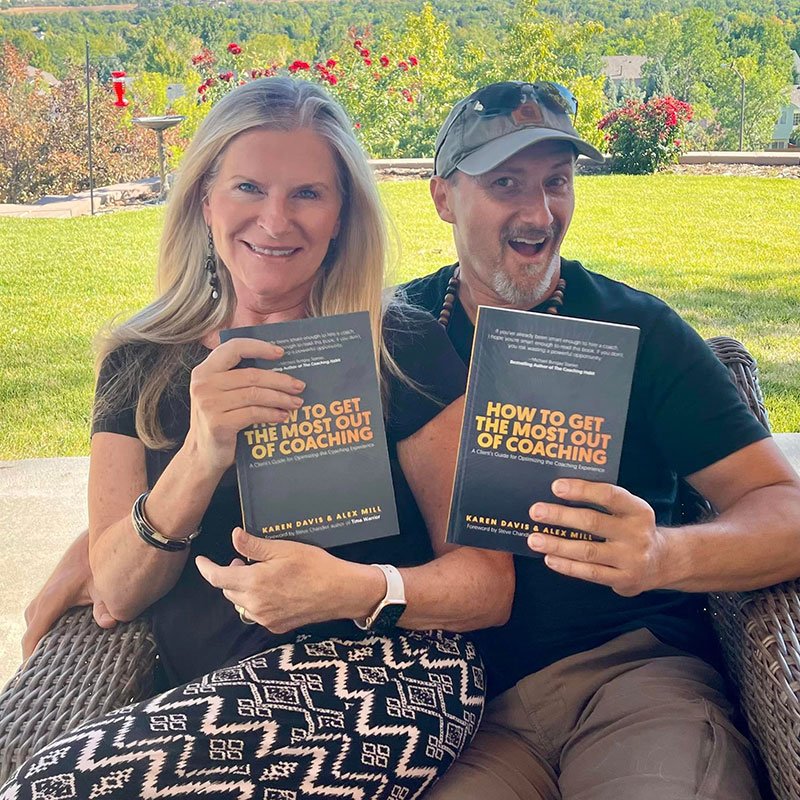 Authors Karen Davis and Alex Mills holding copies of their book