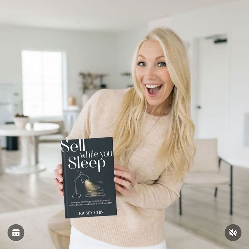 Author Krissy Chin holding her book Sell while you Sleep