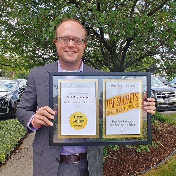 Author Paul Neuberger holding Best Seller plaque