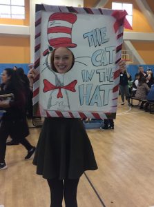 Amelia Forczak with a Cat in the Hat sign